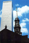 Full color photograph of Trinity Church Steeple with World Trade Center North Tower.